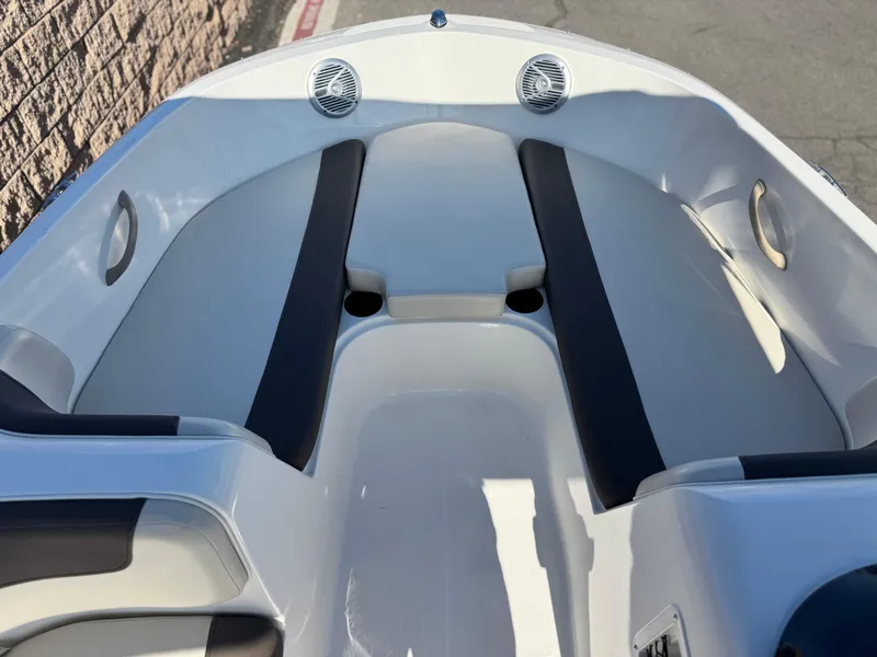 Slide: The Image of 2019 Bayliner Element E16 boat interior with cushioned seating and cup holders. - 7