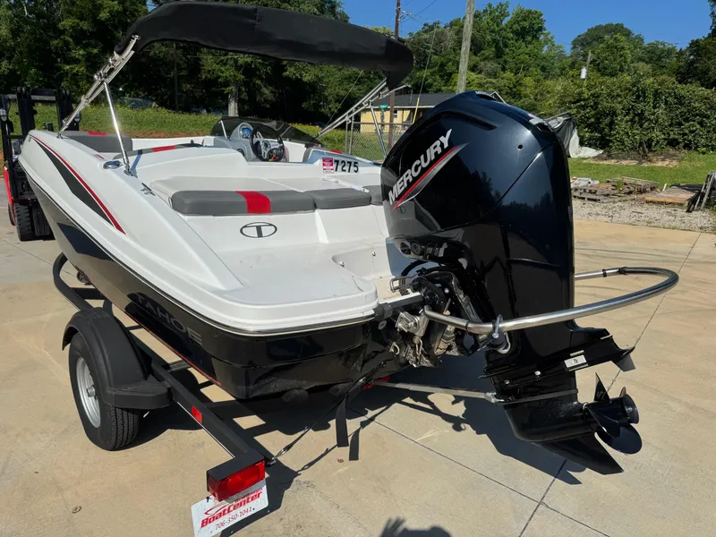 Slide: The Image of 2022 Tahoe T16 boat with Mercury engine on trailer, parked outdoors. - 3