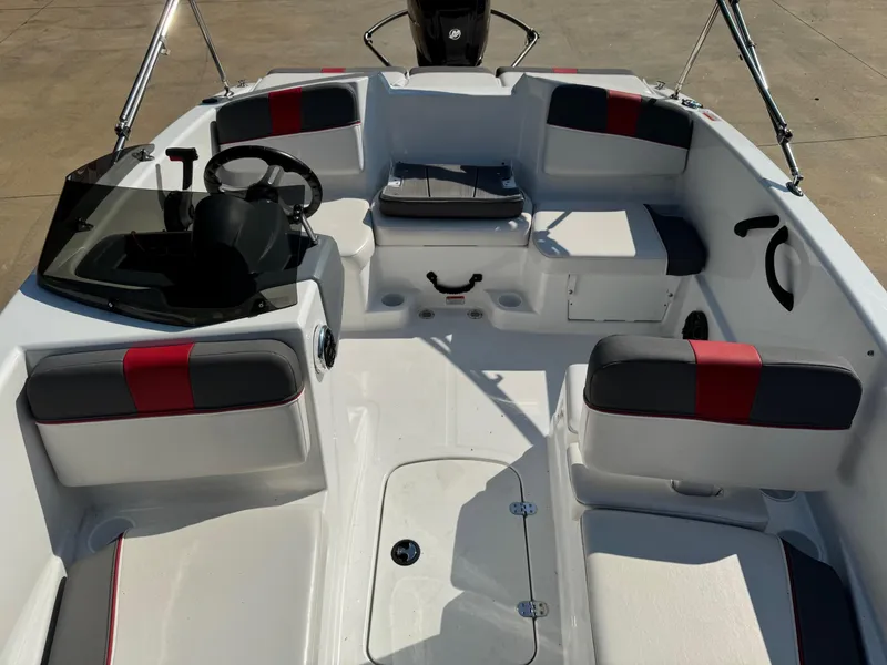 Slide: The Image of 2022 Tahoe T16 boat interior with seating and steering wheel, featuring red and gray accents. - 5