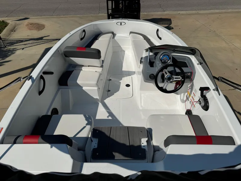 Slide: The Image of 2022 Tahoe T16 boat interior with steering wheel, seating, and dashboard controls. - 7