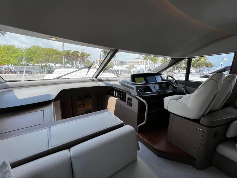 Slide: The Image of Interior of 2022 Princess F55 yacht, featuring modern helm and luxurious seating. - 14