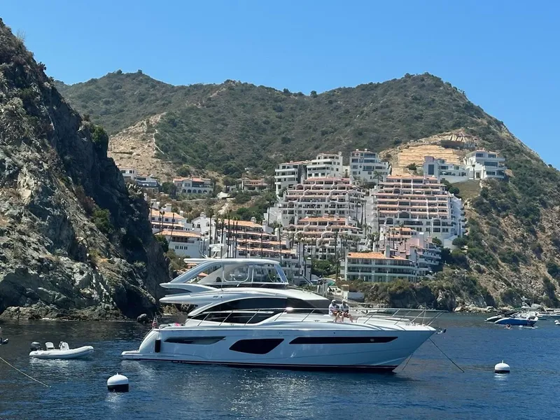 Slide: The Image of Luxury Princess F55 yacht anchored near scenic coastal cliffs, 2022 model. - 3