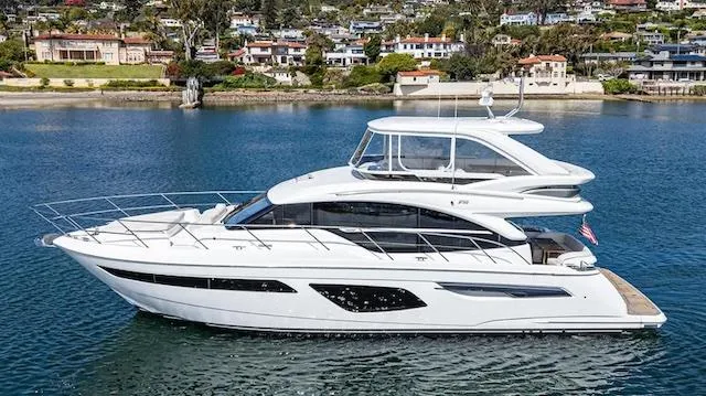 Slide: The Image of Luxury 2022 Princess F55 yacht cruising on serene waters near coastal homes. - 33