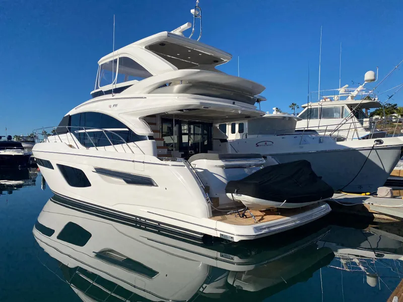 Slide: The Image of Luxury 2022 Princess F55 yacht docked in marina, reflecting on calm water. - 4