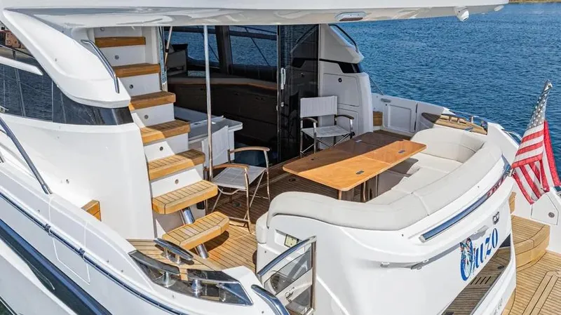 Slide: The Image of Luxurious 2022 Princess F55 yacht with elegant deck seating and wooden accents. - 44