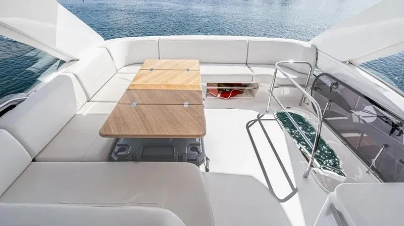Slide: The Image of Luxurious 2022 Princess F55 yacht deck with elegant seating and wooden table. - 45