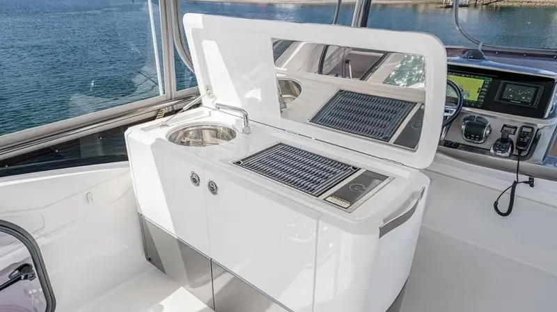Slide: The Image of Luxury yacht Princess F55 2022 model with sleek outdoor kitchen and grill setup. - 46