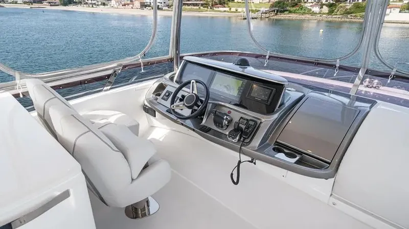 Slide: The Image of Luxurious 2022 Princess F55 yacht helm with modern controls and scenic waterfront view. - 48