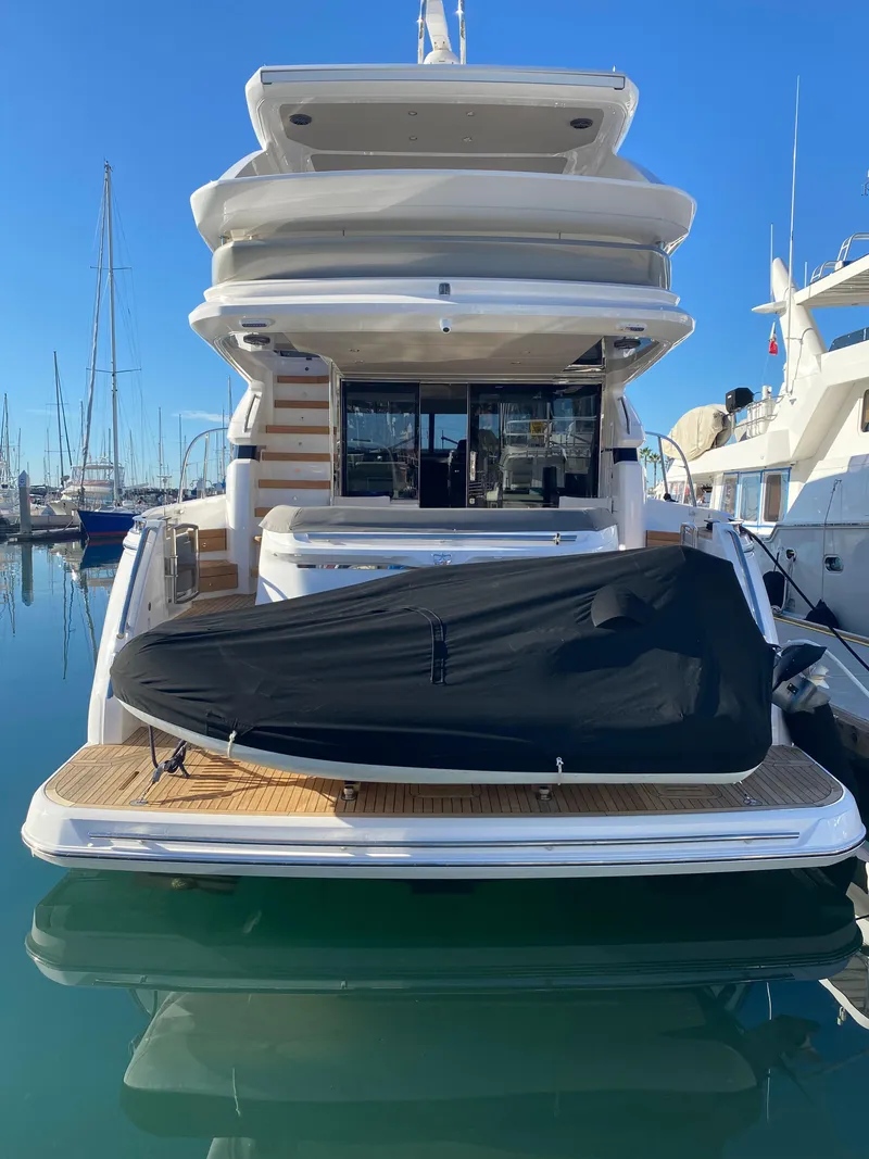 Slide: The Image of 2022 Princess F55 yacht with covered jet ski at marina. - 5