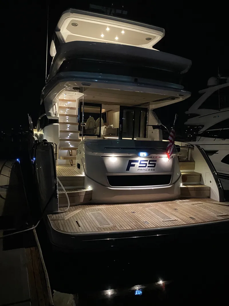 Slide: The Image of Luxury 2022 Princess F55 yacht illuminated at night, docked with elegant design. - 6