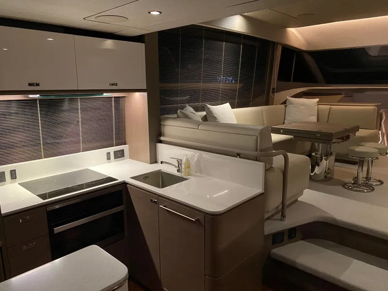 Slide: The Image of Luxurious interior of 2022 Princess F55 yacht with modern kitchen and seating area. - 9