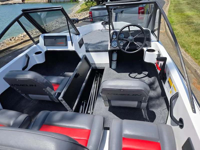 Slide: The Image of 1996 Javelin 360 FS boat interior with steering wheel, seats, and storage compartment. - 11