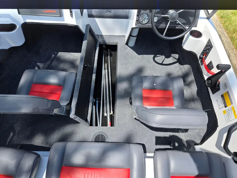 Slide: The Image of Interior of a 1996 Javelin 360 FS boat with gray and red seating. - 12