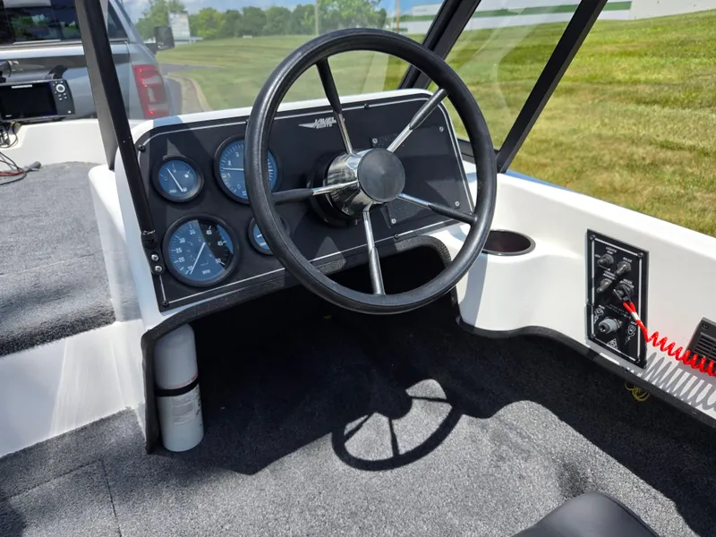 Slide: The Image of Interior of a 1996 Javelin 360 FS boat showing steering wheel and dashboard controls. - 13