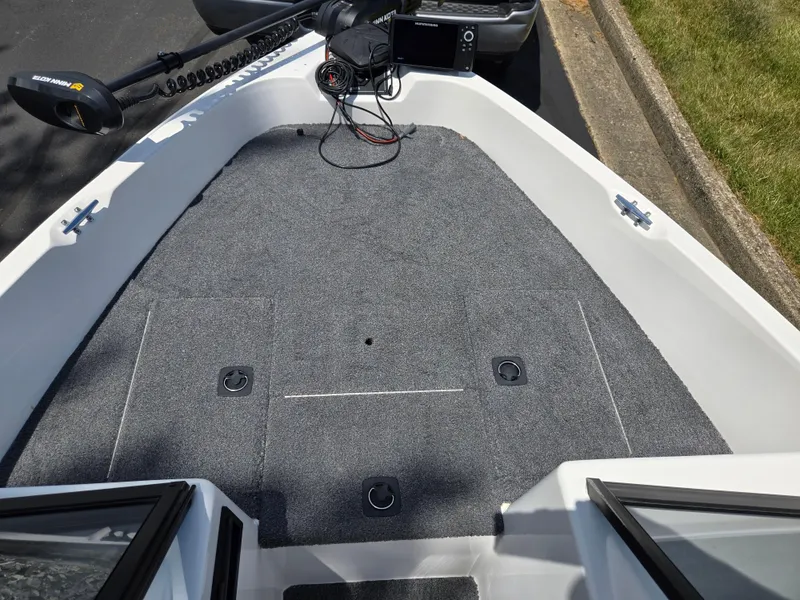 Slide: The Image of 1996 Javelin 360 FS boat deck with carpet, trolling motor, and control panel. - 16