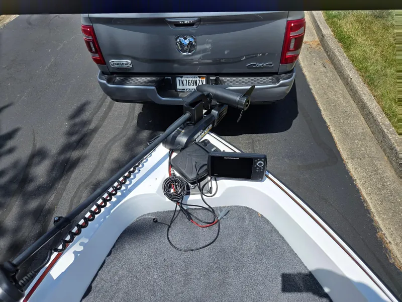 Slide: The Image of Boat with trolling motor and fish finder, parked behind a truck. Javelin 360 FS, 1996 model. - 17