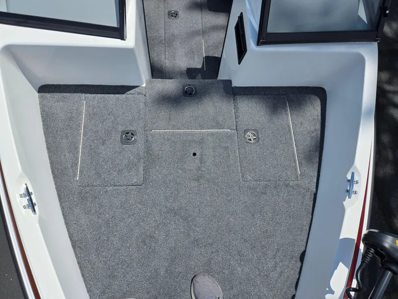 Slide: The Image of 1996 Javelin 360 FS boat interior with gray carpet and storage compartments. - 18