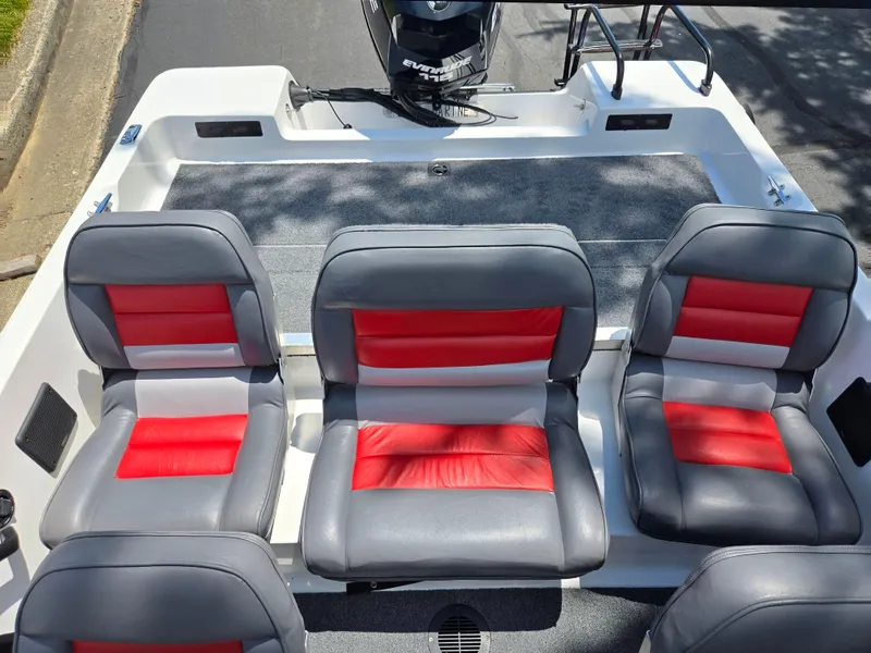 Slide: The Image of 1996 Javelin 360 FS boat interior with gray and red seating, Evinrude motor visible. - 21