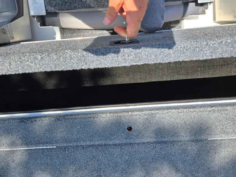 Slide: The Image of Hand opening storage compartment on 1996 Javelin 360 FS boat. - 22