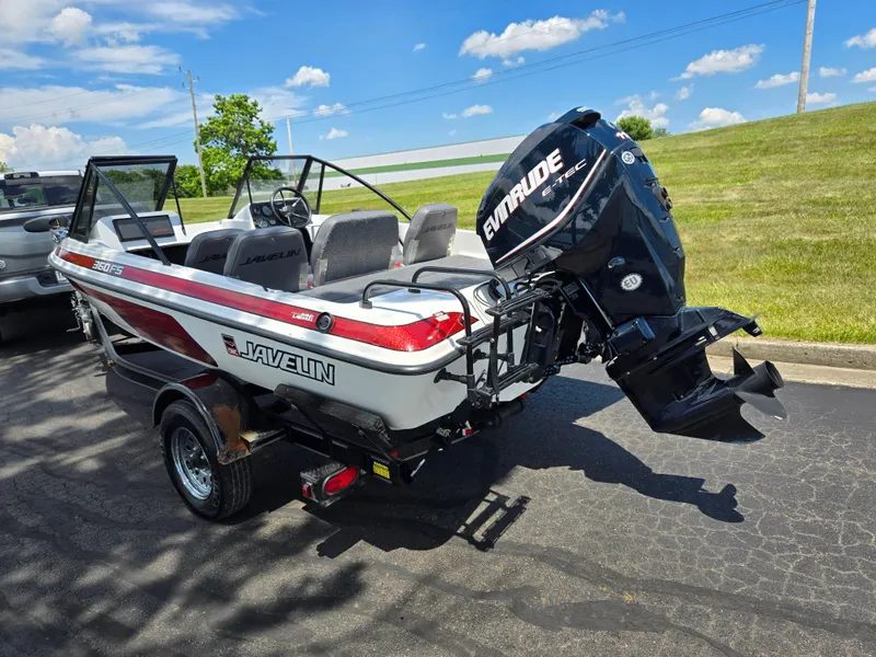 Slide: The Image of 1996 Javelin 360 FS boat with Evinrude motor on trailer, parked outdoors. - 3