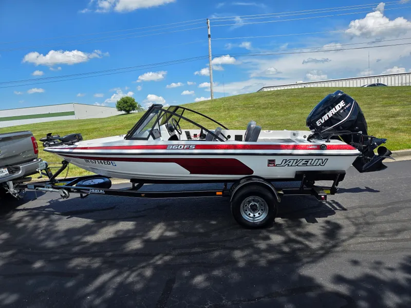 Slide: The Image of 1996 Javelin 360 FS boat on trailer, Evinrude motor, parked outdoors under blue sky. - 4