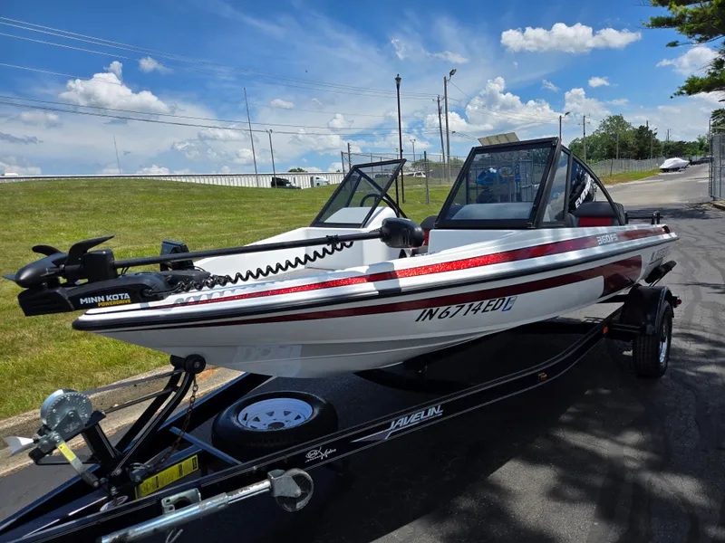Slide: The Image of 1996 Javelin 360 FS boat with Minn Kota motor on trailer, parked outdoors. - 5