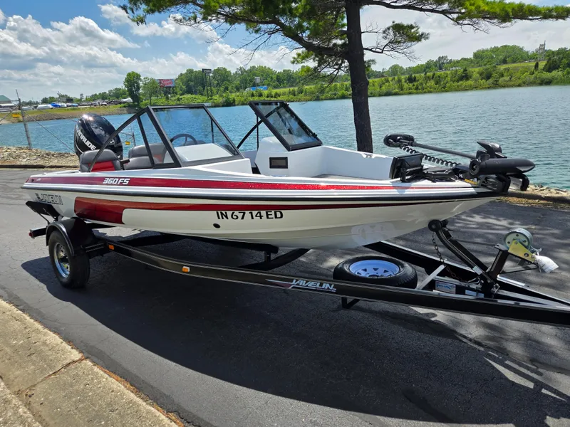 Slide: The Image of 1996 Javelin 360 FS boat on trailer by a lake, under a sunny sky. - 9