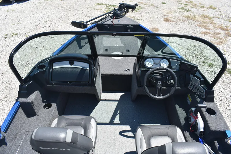 Slide: The Image of 2022 Lund 1650 Angler Sport boat interior with steering wheel and seating. - 10