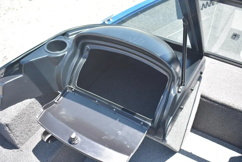 Slide: The Image of 2022 Lund 1650 Angler Sport boat storage compartment with open lid. - 11