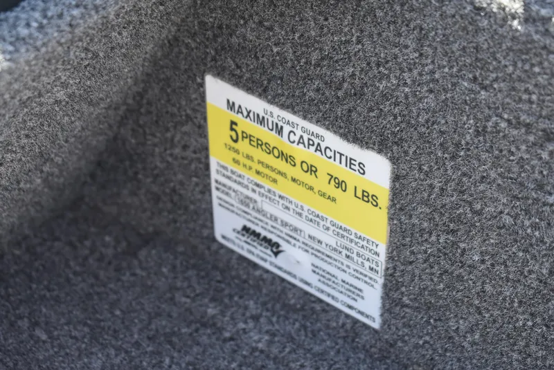Slide: The Image of U.S. Coast Guard capacity label on 2022 Lund 1650 Angler Sport boat, 5 persons or 790 lbs. - 14