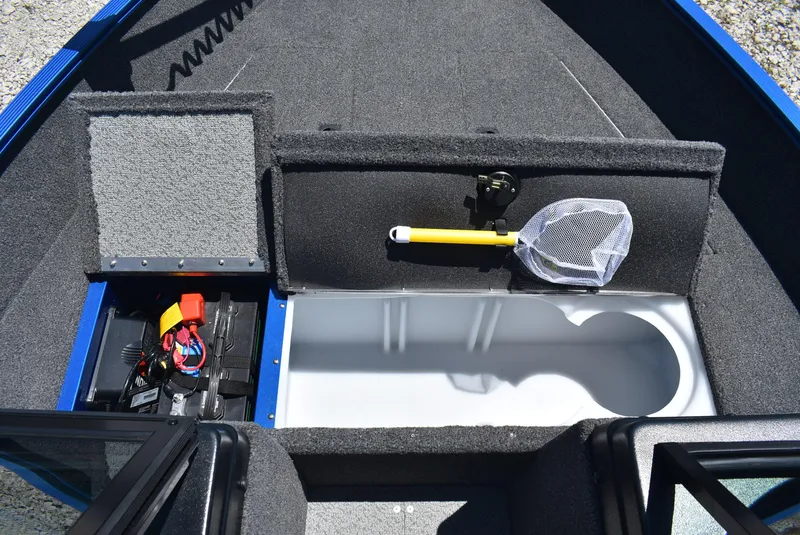 Slide: The Image of 2022 Lund 1650 Angler Sport boat interior with storage compartments and fishing net. - 15