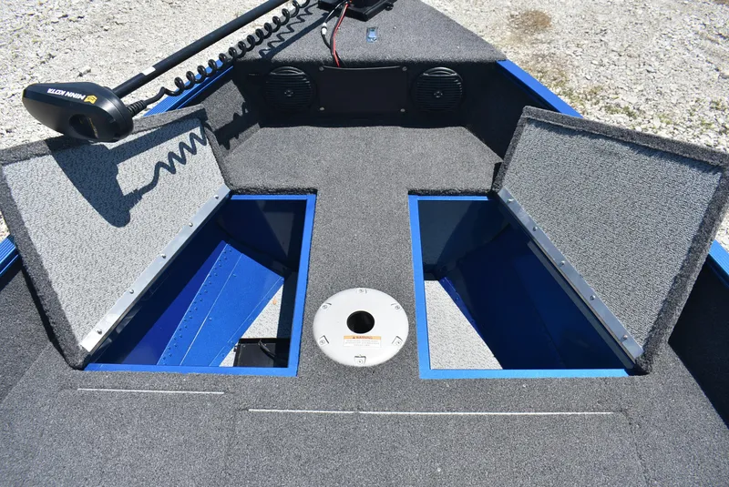 Slide: The Image of 2022 Lund 1650 Angler Sport boat interior with open storage compartments. - 16