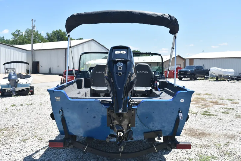 Slide: The Image of 2022 Lund 1650 Angler Sport boat with 60 HP motor, parked outdoors on gravel. - 6