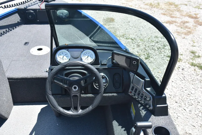 Slide: The Image of 2022 Lund 1650 Angler Sport boat dashboard with steering wheel and gauges. - 9
