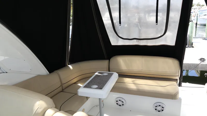 Slide: The Image of 2012 Cruisers Yachts 350 Express interior with beige seating and table. - 12