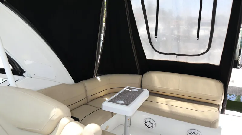 Slide: The Image of 2012 Cruisers Yachts 350 Express interior with beige seating and table. - 15