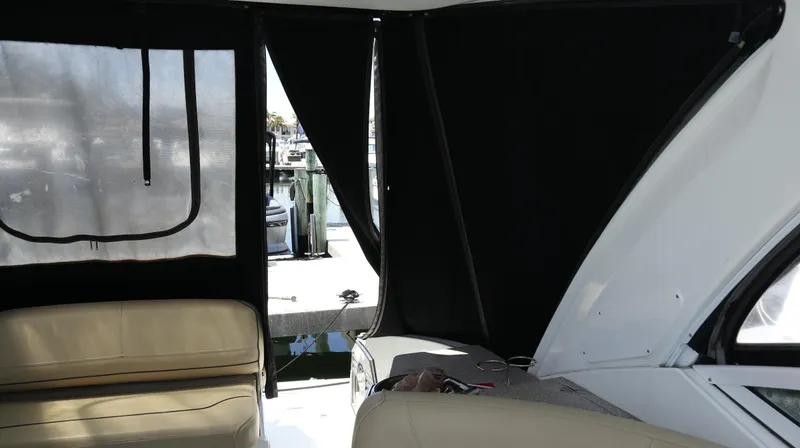 Slide: The Image of Interior view of 2012 Cruisers Yachts 350 Express with seating and marina backdrop. - 16
