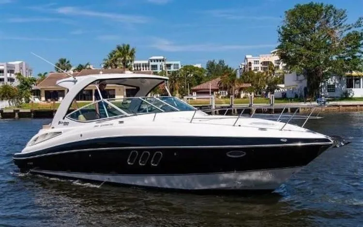 Slide: The Image of 2012 Cruisers Yachts 350 Express on water, sleek design, sunny day, waterfront homes in background. - 2