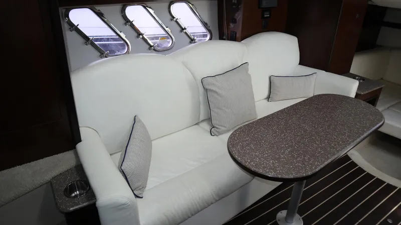 Slide: The Image of Interior of 2012 Cruisers Yachts 350 Express with white sofa and table. - 21