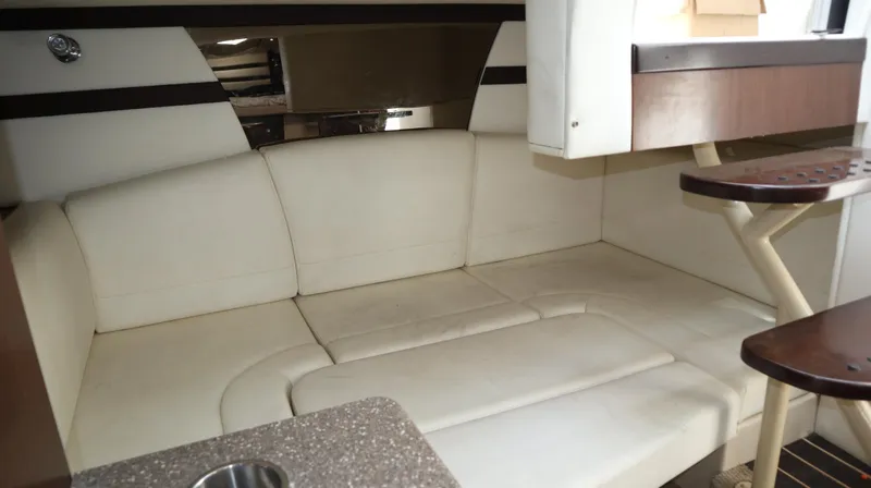 Slide: The Image of Interior of 2012 Cruisers Yachts 350 Express with white leather seating and wooden accents. - 22