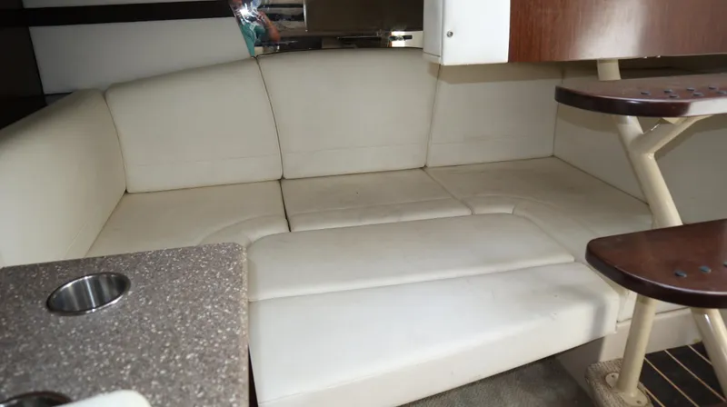 Slide: The Image of Interior of 2012 Cruisers Yachts 350 Express with white leather seating and wooden accents. - 23