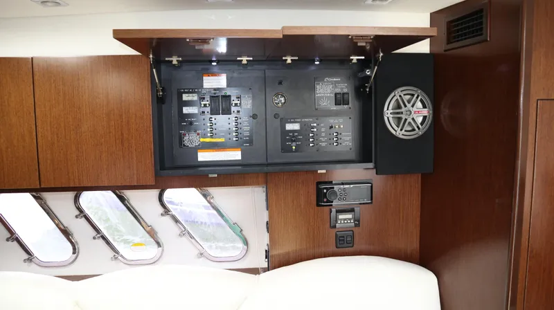 Slide: The Image of 2012 Cruisers Yachts 350 Express interior with control panel and speaker system. - 24