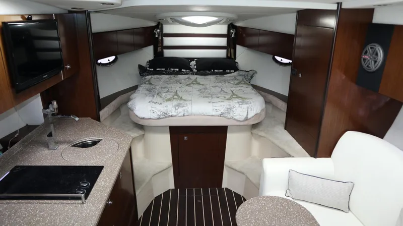 Slide: The Image of Luxurious interior of 2012 Cruisers Yachts 350 Express with bed, kitchenette, and seating area. - 28