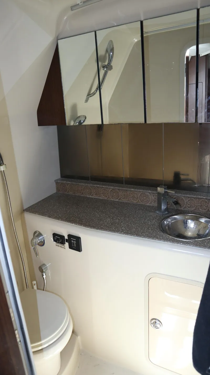 Slide: The Image of 2012 Cruisers Yachts 350 Express bathroom with sink, mirror, and toilet. - 29