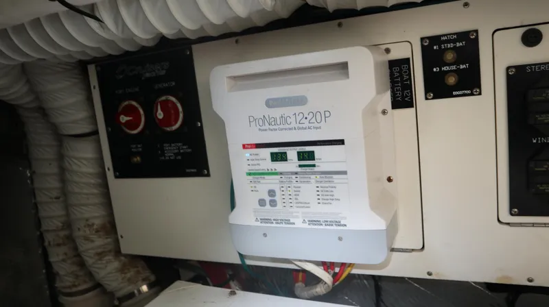 Slide: The Image of Electrical panel on a 2012 Cruisers Yachts 350 Express, featuring ProNautic 12-20P charger. - 32