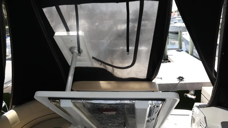 Slide: The Image of 2012 Cruisers Yachts 350 Express interior with covered seating and marina view. - 36