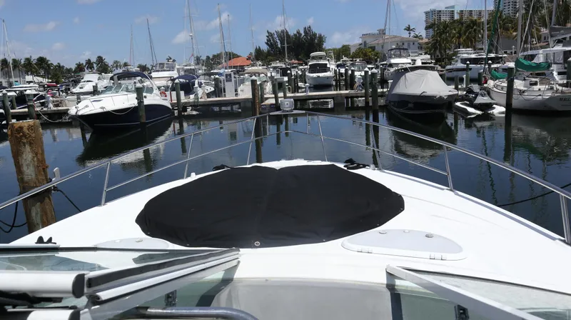 Slide: The Image of 2012 Cruisers Yachts 350 Express docked in a marina, surrounded by other boats. - 37