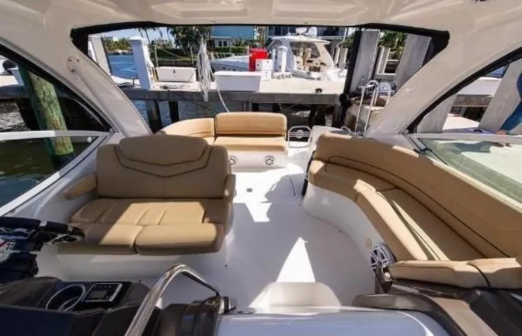 Slide: The Image of Interior view of 2012 Cruisers Yachts 350 Express with beige seating and open deck. - 4