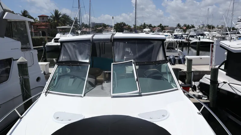 Slide: The Image of 2012 Cruisers Yachts 350 Express docked at a marina under a clear sky. - 40