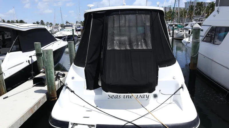 Slide: The Image of 2012 Cruisers Yachts 350 Express docked at marina, rear view with black cover. - 41